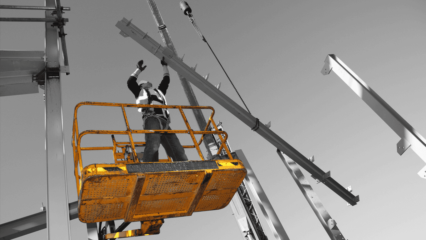 Construction worker on an elevated platform guiding steel beams into place, symbolising how MLOps with Databricks provides strong foundations for building scalable AI systems.